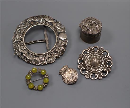 A small Chinese white metal circular photograph frame, a Victorian silver pill box and three assorted brooches.